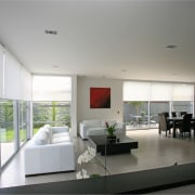 A view of these living areas featuring stained architecture, ceiling, house, interior design, living room, real estate, gray