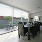 A view of these living areas featuring stained dining room, interior design, property, real estate, room, table, window, gray, white