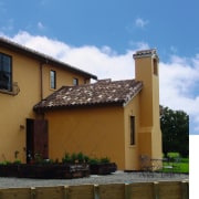 A view of roof tiles from Solerati. - building, cottage, estate, facade, home, house, property, real estate, residential area, roof, sky, villa, window, brown, teal