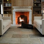 A view of the Aged limestone Dalle de fireplace, floor, flooring, hardwood, hearth, home, interior design, laminate flooring, living room, tile, wood, wood burning stove, wood flooring, gray, brown