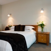 A vie wof some furniture from East West bed, bed frame, bedroom, ceiling, floor, furniture, home, interior design, room, suite, wall, gray