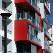 An exterior view of the discovery point apartment apartment, architecture, balcony, building, commercial building, condominium, corporate headquarters, elevation, facade, house, mixed use, property, real estate, residential area, black, white