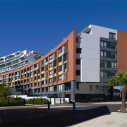 An exterior view of the discovery point apartment apartment, building, city, commercial building, condominium, corporate headquarters, elevation, facade, home, hotel, metropolitan area, mixed use, neighbourhood, property, real estate, residential area, sky, tower block, blue, black