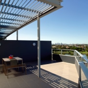 A view of the utdoor balcony featuring tiled apartment, architecture, balcony, daylighting, house, penthouse apartment, property, real estate, roof, teal, black