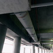 A view of the hydraulic system that incorporates aerospace engineering, airplane, architecture, aviation, beam, ceiling, pipe, steel, structure, black, gray