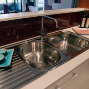 A view of the hydraulic system that A countertop, kitchen, plumbing fixture, sink, black