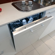 The intergrated dishwasher helps to give the kitchen automotive exterior, countertop, floor, home appliance, kitchen, kitchen stove, major appliance, gray