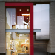 An exterior viow of the puma shopfront,  architecture, door, facade, house, interior design, window, gray