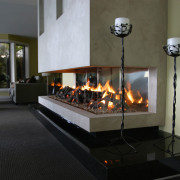 A view of a fireplace from Living Flame. fireplace, hearth, heat, wood burning stove, black, gray