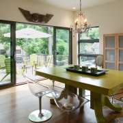 A view of the dining area featuring varnished dining room, furniture, home, house, interior design, living room, real estate, room, table, window, brown, gray