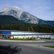 An exterior view of the architecturally design shopping alps, architecture, controlled access highway, fixed link, highway, metropolitan area, mountain, mountain range, plant, road, sky, skyway, transport, tree, teal, black