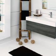 View of this bathroom featuring white cabinetry, stainless bathroom, bathroom accessory, bathroom cabinet, bathroom sink, chest of drawers, floor, flooring, furniture, interior design, plumbing fixture, product, product design, room, sink, tap, white