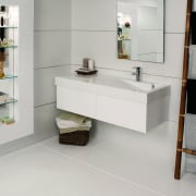 View of this bathroom featuring white cabinetry, stainless bathroom, bathroom accessory, bathroom cabinet, floor, flooring, furniture, interior design, product design, shelf, shelving, sink, tap, tile, gray