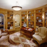 A view of the library featuring timber shelving, bookcase, ceiling, estate, furniture, home, interior design, library, living room, property, real estate, brown