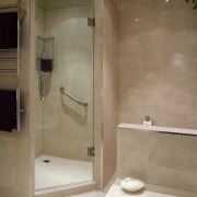 A view of a bathroom by Bathroom Direct. bathroom, floor, plumbing fixture, room, shower, tile, toilet seat, wall, brown