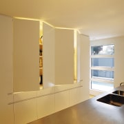 An interio view of the kitchen featuring timber cabinetry, floor, home, interior design, light fixture, lighting, room, shelf, wall, orange