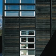 An exterior view of this contemporary home designed architecture, building, door, facade, window, wood, black