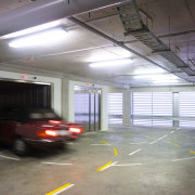 A view of the Precinct Apartments constructed by metropolitan area, motor vehicle, parking, parking lot, public space, gray