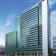 A view of a building built in conjunction architecture, building, city, commercial building, condominium, corporate headquarters, daytime, downtown, facade, headquarters, hotel, metropolis, metropolitan area, mixed use, plaza, real estate, sky, skyscraper, tower block, urban area, teal