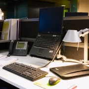 A view of this desk featuring laptop, phone, desktop computer, electronic device, furniture, laptop, netbook, personal computer, product, product design, technology, black