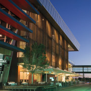 An exterior view of the Restaurants &amp; shops architecture, building, commercial building, condominium, convention center, corporate headquarters, facade, headquarters, hotel, metropolitan area, mixed use, real estate, reflection, residential area, sky, structure, blue, green