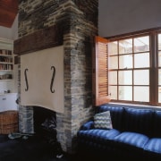 A view of the interior living areas featuring fireplace, hearth, home, interior design, living room, loft, property, real estate, room, wall, window, black