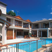 An exterior view of the family home designed apartment, cottage, estate, facade, home, house, leisure, mansion, property, real estate, residential area, resort, swimming pool, villa, blue, black