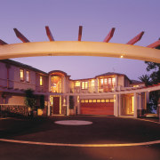 An exterior view of the family home designed arch, estate, facade, hacienda, home, lighting, property, real estate, red, black