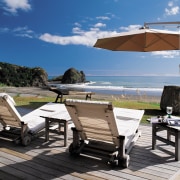 An exterior view of this coastal piha home leisure, outdoor furniture, outdoor structure, patio, property, real estate, resort, sunlounger, table, vacation