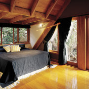 a view of the aster bedroom featuring bed, architecture, bedroom, ceiling, floor, flooring, home, house, interior design, property, real estate, room, window, wood