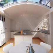 An interior view of the living areas featuring architecture, ceiling, daylighting, interior design, product design, table, gray