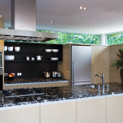 A view of this kitchen featuring polished timber countertop, interior design, kitchen, gray