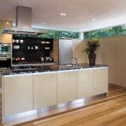 A view of this kitchen featuring polished timber cabinetry, countertop, interior design, kitchen, gray, brown