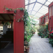 An interior view of the glasshouse where the architecture, courtyard, facade, floristry, flower, home, house, outdoor structure, plant, real estate, window, red