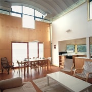 An interior view of the living areas featuring ceiling, daylighting, furniture, interior design, living room, real estate, table, white