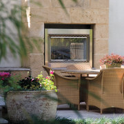 An exterior view of this renovated heritage home flower, furniture, home, outdoor structure, patio, plant, table, window, gray