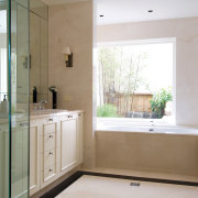 A view of the master bathroom featuring recessed bathroom, bathroom cabinet, countertop, floor, flooring, home, interior design, plumbing fixture, property, real estate, room, sink, tile, window, gray