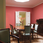 A view of the dining area featuring dark ceiling, chair, dining room, floor, flooring, furniture, hardwood, home, interior design, living room, room, table, wall, window, wood, brown, black