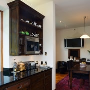 A view of this kitchen feautring solida aged cabinetry, countertop, cuisine classique, hardwood, interior design, kitchen, living room, room, gray, black