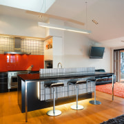 A view of this kitchen featuring kauri flooring, architecture, countertop, house, interior design, kitchen, loft, real estate, room, gray