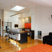 A view of this kitchen featuring kauri flooring, ceiling, floor, flooring, interior design, living room, real estate, room, gray