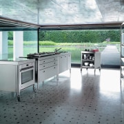 A view of this kitchen featuring stainless steel floor, flooring, gray