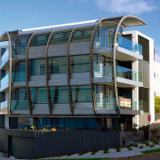 A view of this Apartment block featuring Louvres apartment, architecture, building, commercial building, condominium, corporate headquarters, elevation, facade, home, house, metropolitan area, mixed use, neighbourhood, property, real estate, residential area, teal, black