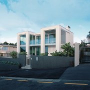 An exterior view of this clifftop house designed apartment, architecture, building, commercial building, condominium, corporate headquarters, daytime, elevation, estate, facade, home, house, neighbourhood, property, real estate, residential area, sky, black, teal