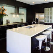 The deep island has enough bench space for cabinetry, countertop, interior design, kitchen, real estate, room, black, white