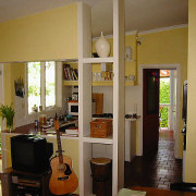 The previously box-like kitchen area has been opened door, furniture, home, interior design, room, window, brown