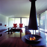 A view of the interior licing areas featuring ceiling, fireplace, hearth, interior design, living room, room, table, gray