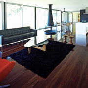 A view of the interior licing areas featuring floor, flooring, furniture, hardwood, interior design, laminate flooring, living room, real estate, room, table, wood, wood flooring, white, red