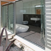 A view of some kitchen and bathroom cabinetry architecture, door, facade, glass, house, real estate, window, gray