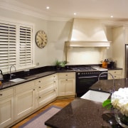 A view of this traditional kitchen featuring antique cabinetry, countertop, cuisine classique, interior design, kitchen, real estate, room, gray